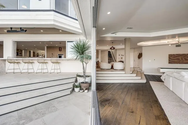 a living room with furniture and a floor to ceiling window