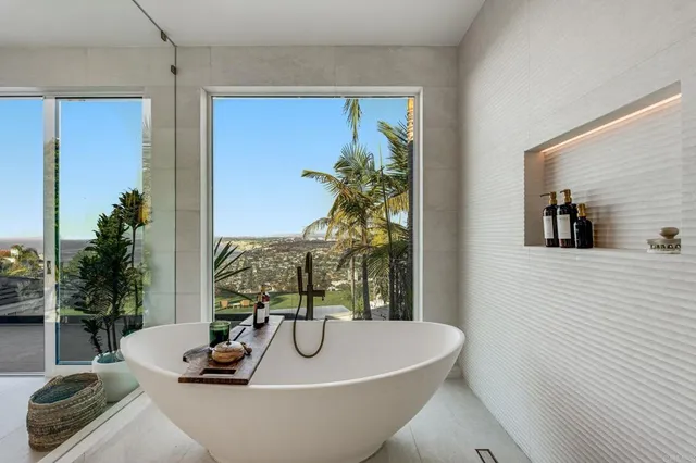 a bathroom with a granite countertop sink toilet mirror and shower