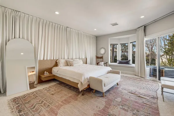 a spacious bedroom with a bed and a couch
