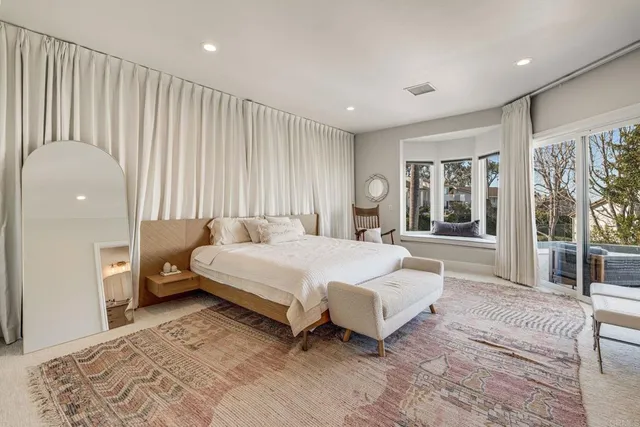 a spacious bedroom with a bed and a couch