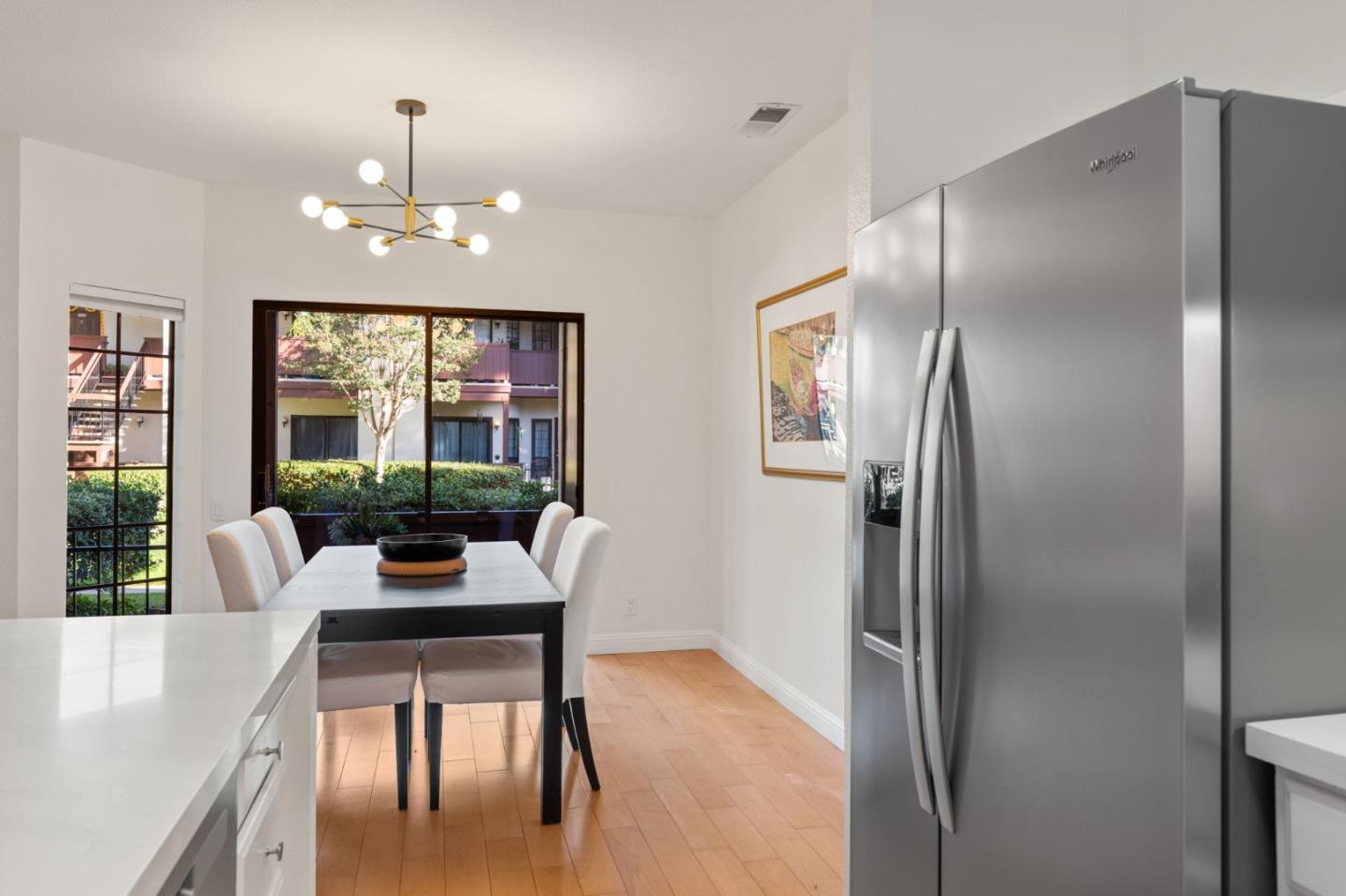 473 Costa Mesa Terrace, Unit C Sunnyvale, CA 94085 - Photo 12 of 40 a view of a dining room with furniture window and wooden floor