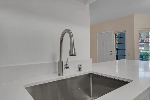 a view of a kitchen counter space with windows