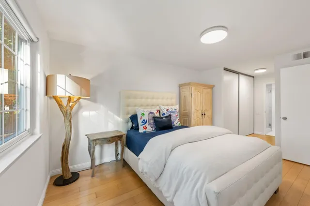 a bedroom with a bed and a window