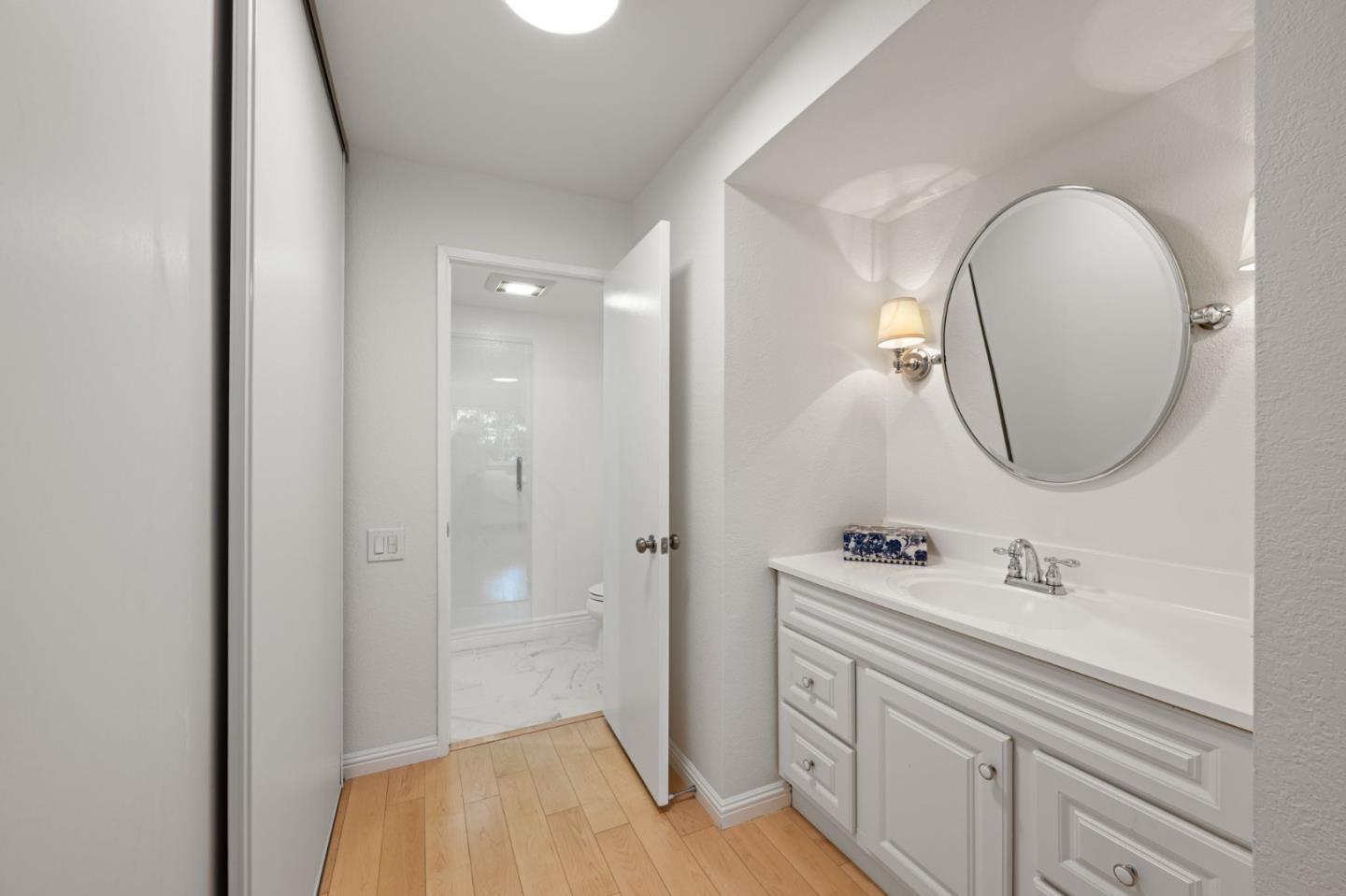 473 Costa Mesa Terrace, Unit C Sunnyvale, CA 94085 - Photo 21 of 40 a bathroom with a sink a toilet and a mirror