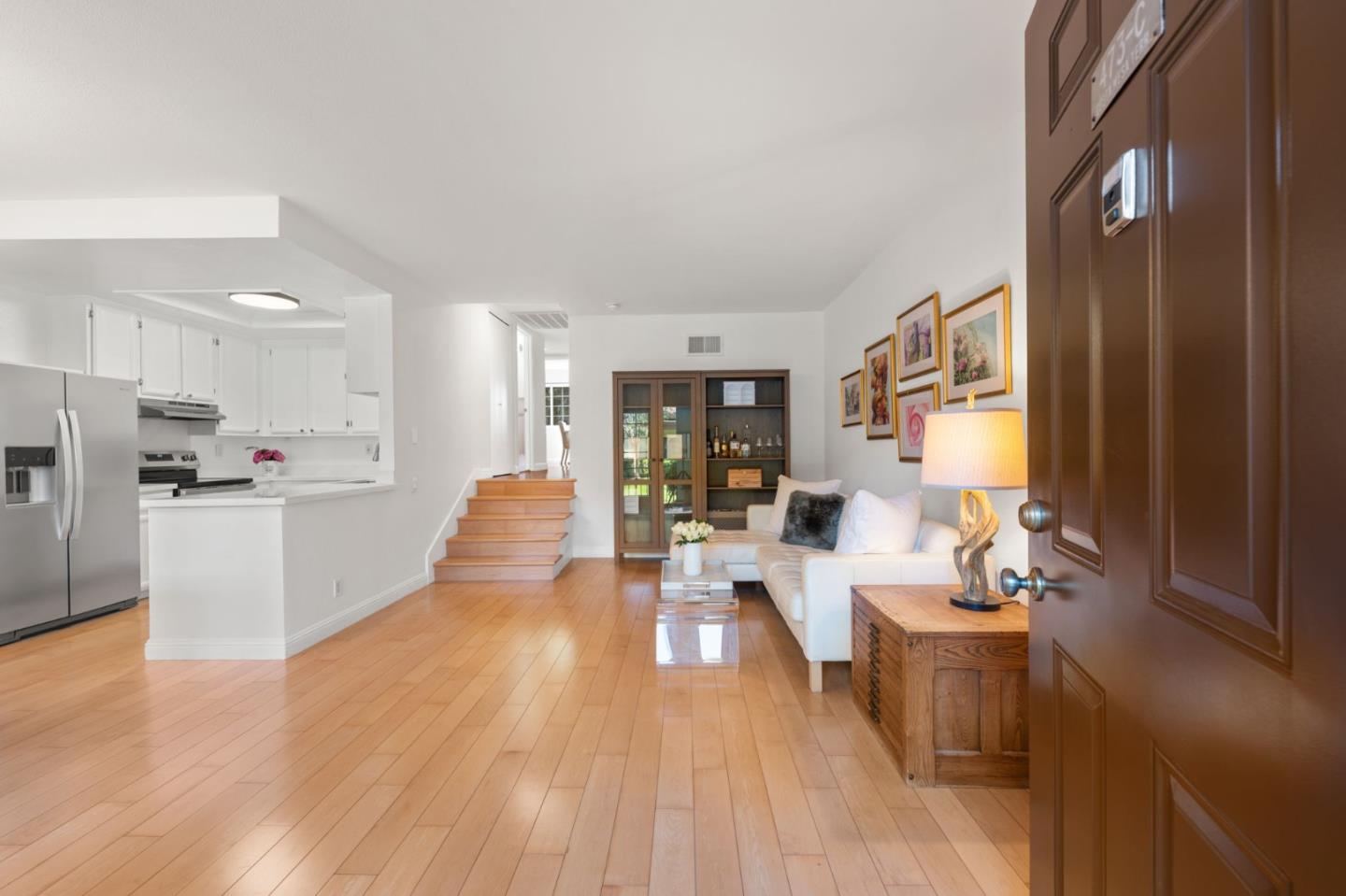 473 Costa Mesa Terrace, Unit C Sunnyvale, CA 94085 - Photo 4 of 40 a large living room with stainless steel appliances kitchen island granite countertop a large window and white cabinets