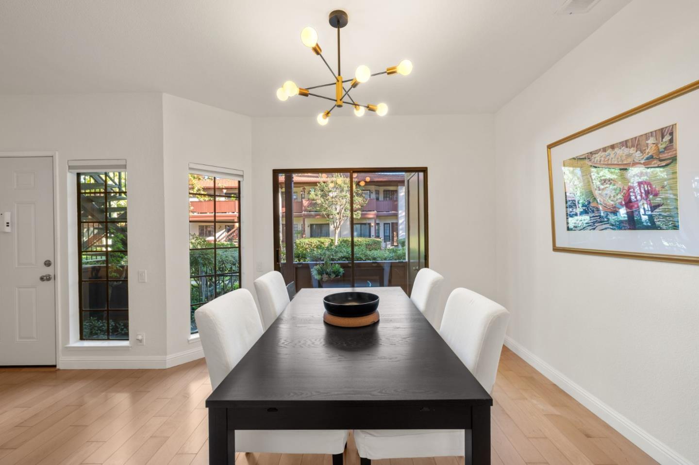 473 Costa Mesa Terrace, Unit C Sunnyvale, CA 94085 - Photo 7 of 40 a view of a dining room with furniture wooden floor and chandelier