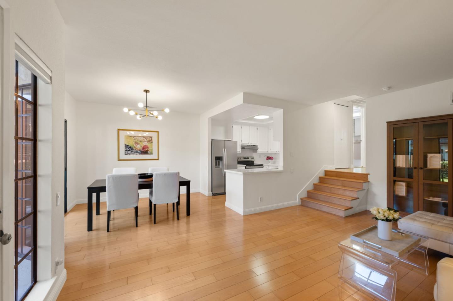 473 Costa Mesa Terrace, Unit C Sunnyvale, CA 94085 - Photo 8 of 40 a large living room with furniture and wooden floor