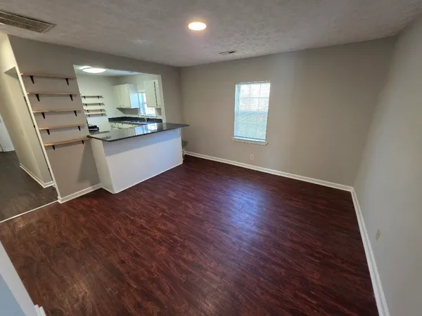 a view of kitchen with cabinets and wooden floor