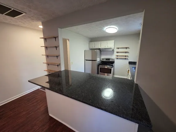 a view of kitchen island with cabinets