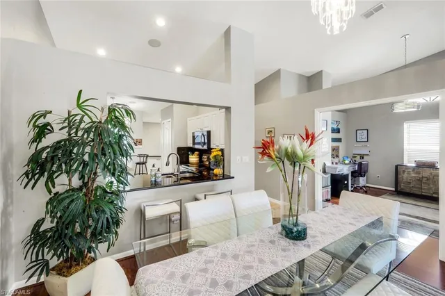 a living room with furniture potted plant and a flat screen tv
