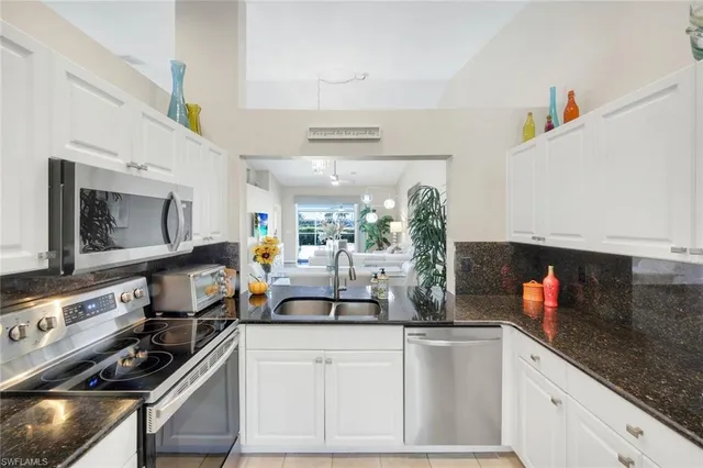 a kitchen with a microwave a stove and cabinets