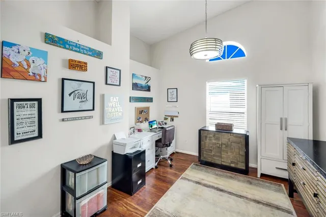 a view of a livingroom with workspace and a window