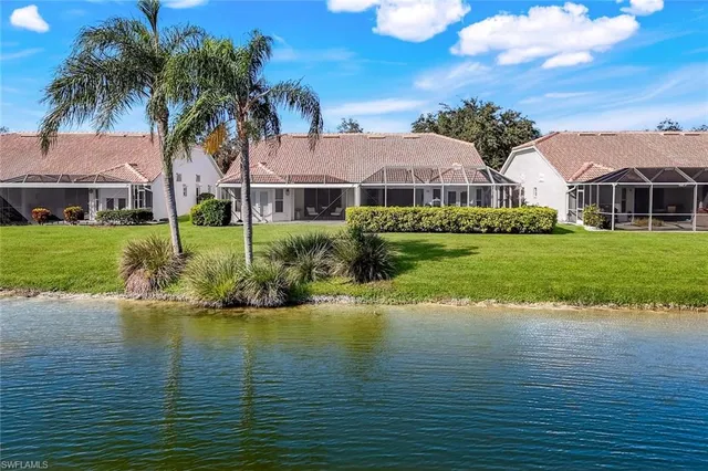 a front view of house with yard and lake