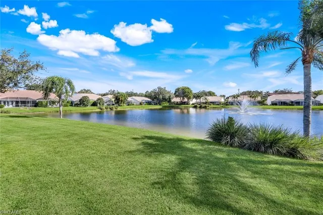 a view of a lake with houses in the background