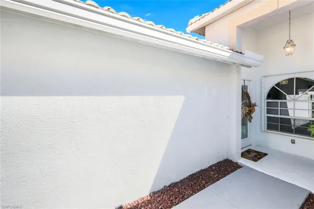 a front view of a house with a yard and a garden