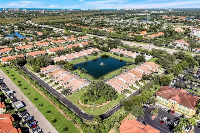 an aerial view of a house with a lake