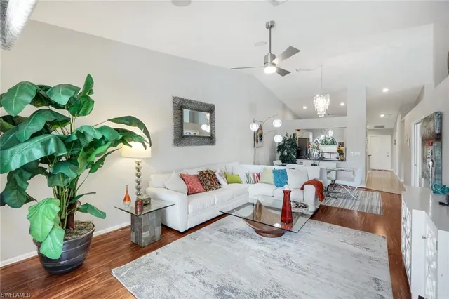 a living room with furniture and a potted plant