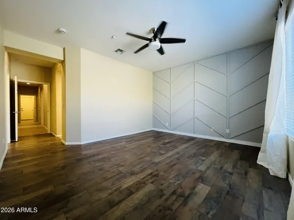 a view of a livingroom with a ceiling fan and wooden floor