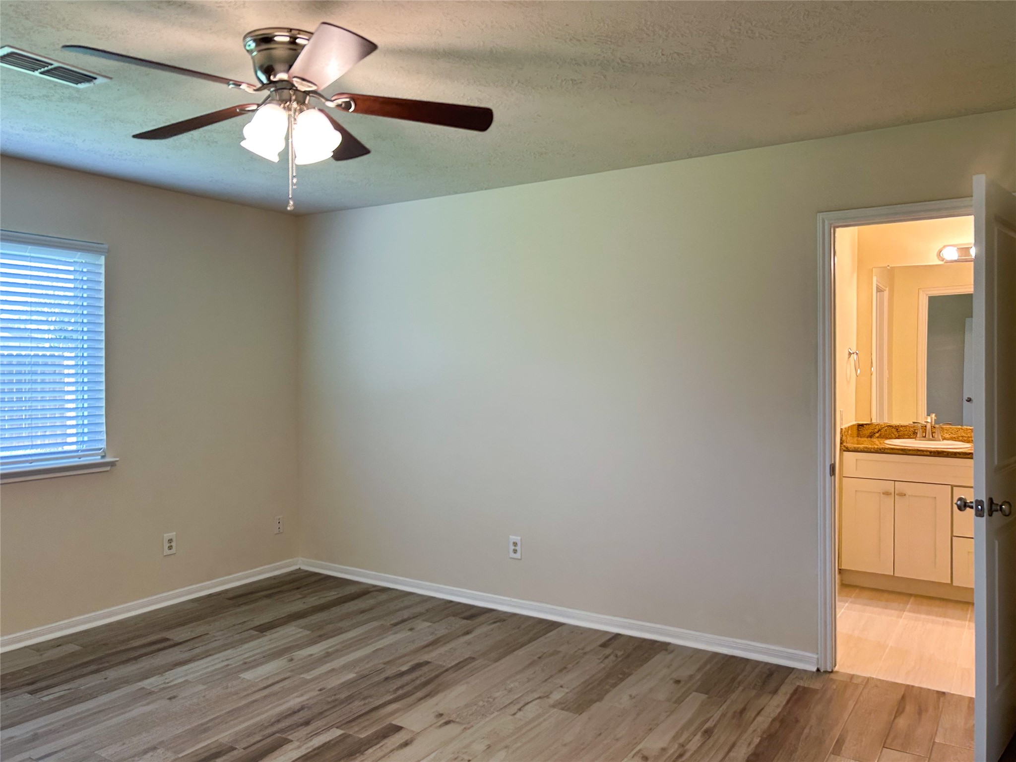 29219 Waltham Street Spring, TX 77386 - Photo 13 of 23 an empty room with wooden floor chandelier fan and windows