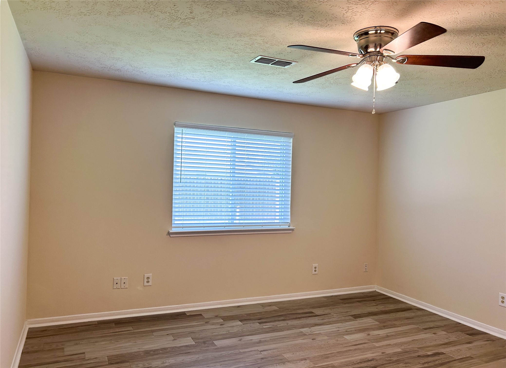29219 Waltham Street Spring, TX 77386 - Photo 14 of 23 an empty room with wooden floor and windows