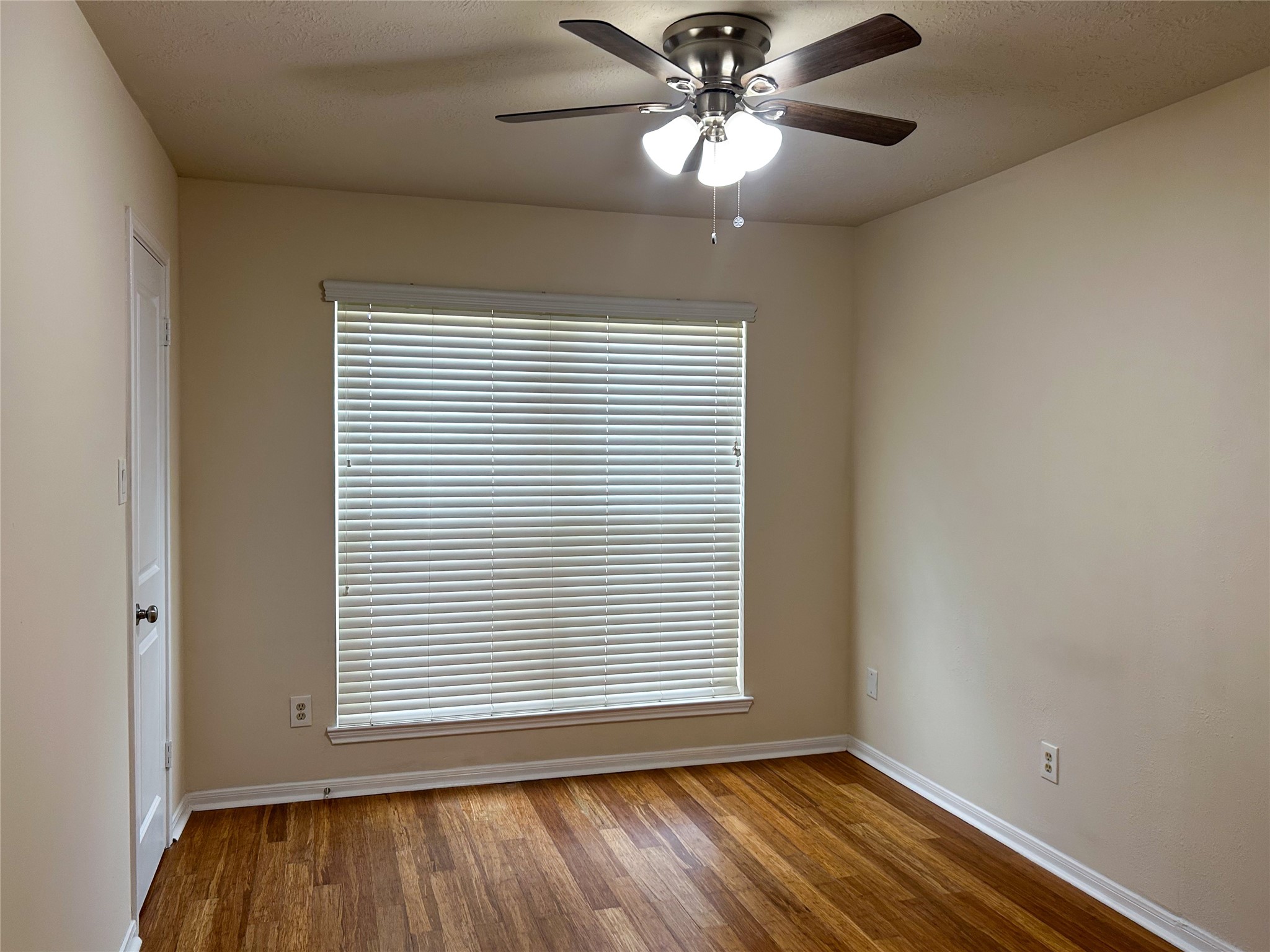29219 Waltham Street Spring, TX 77386 - Photo 19 of 23 an empty room with wooden floor chandelier fan and windows