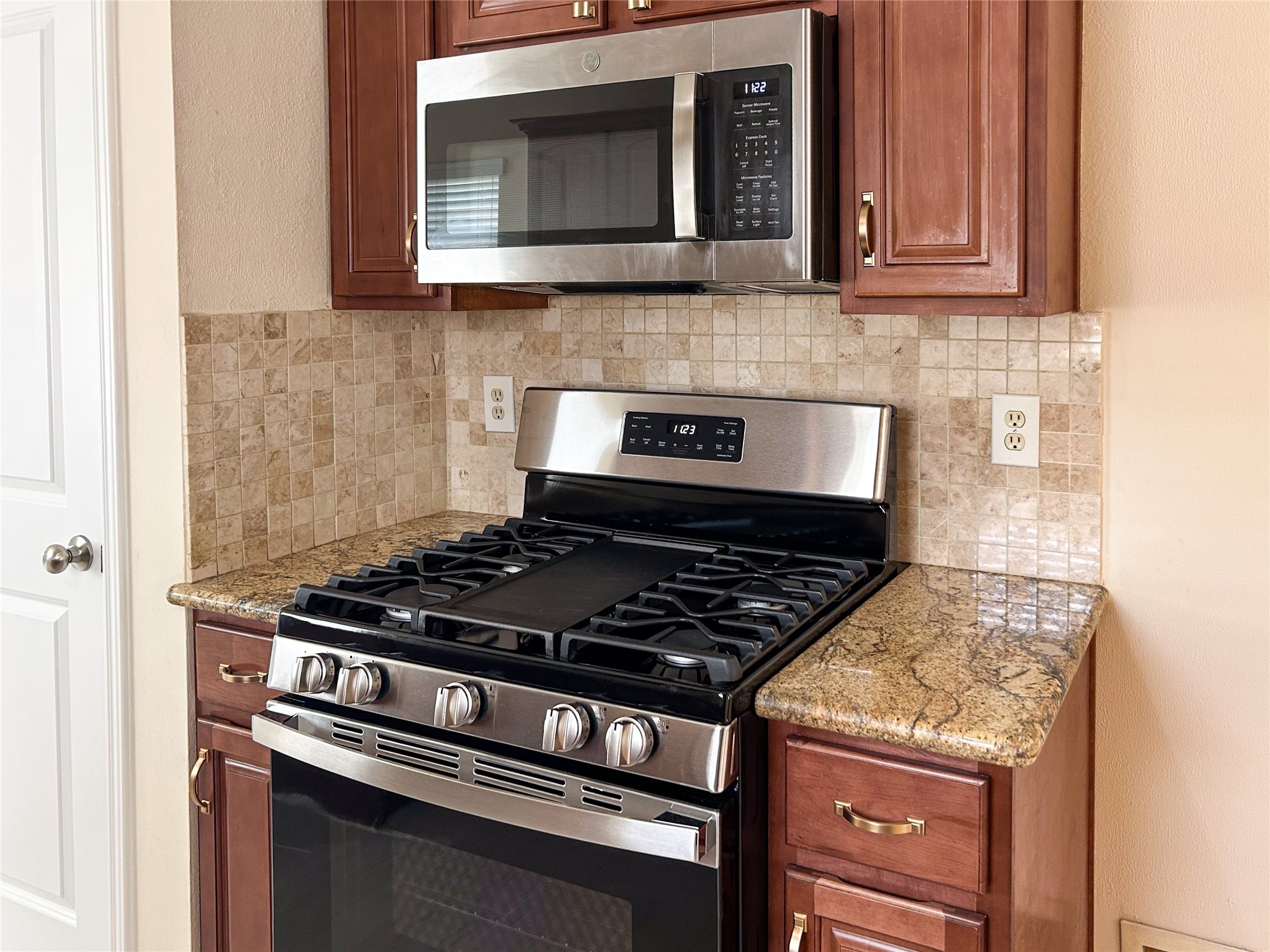 29219 Waltham Street Spring, TX 77386 - Photo 8 of 23 a kitchen with granite countertop a stove and a microwave