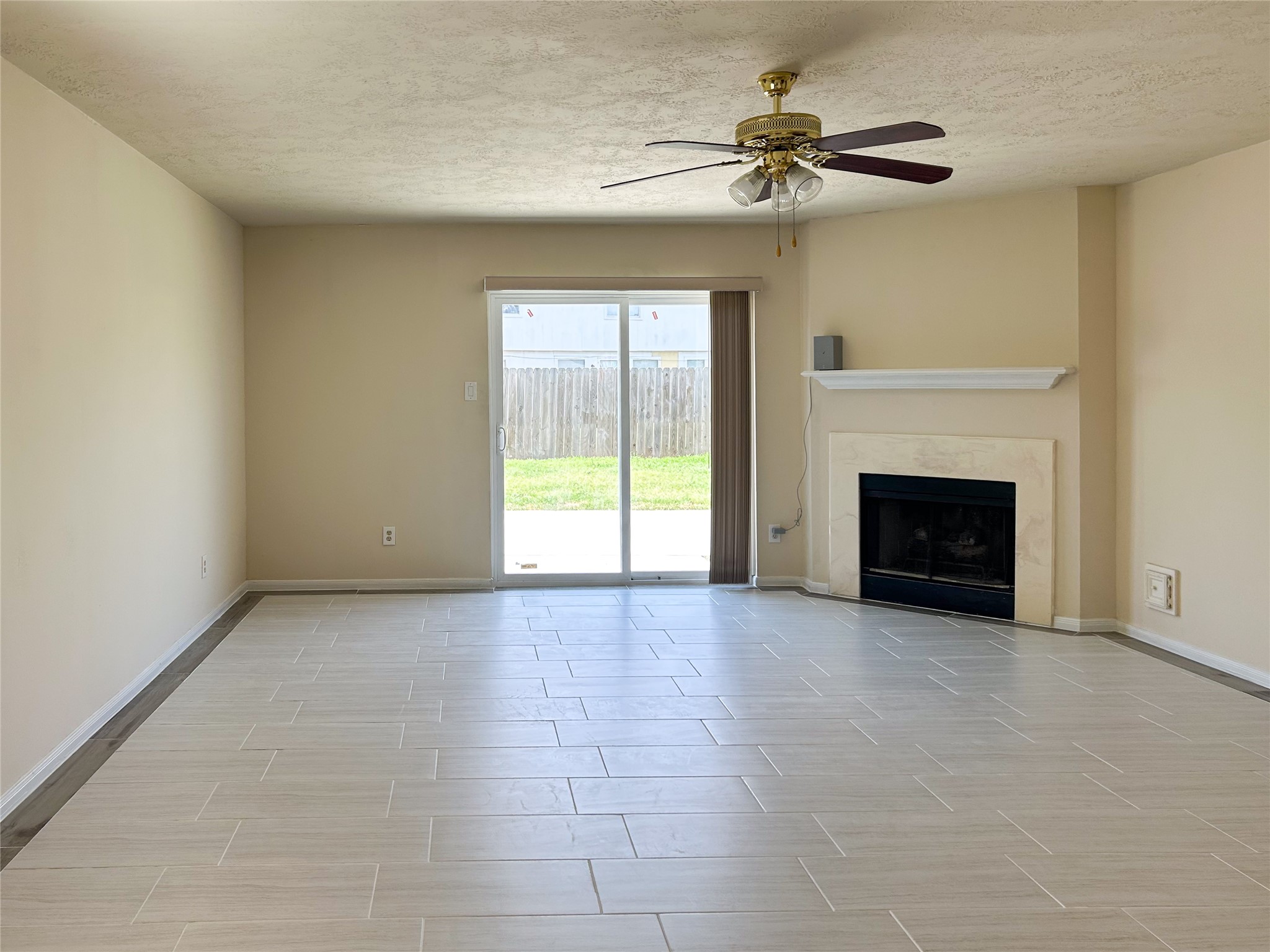 29219 Waltham Street Spring, TX 77386 - Photo 9 of 23 a view of an empty room with a fireplace and a window