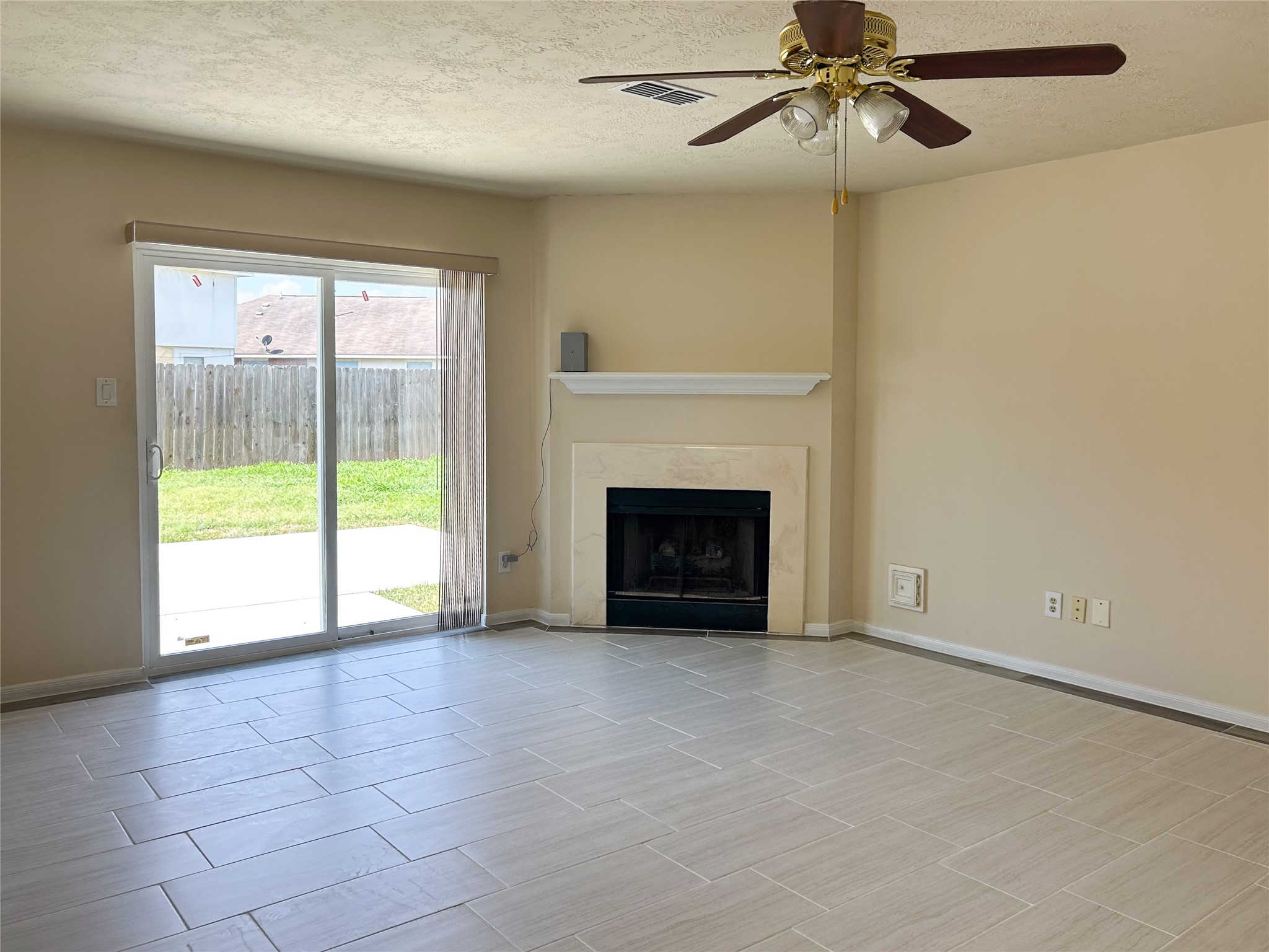 29219 Waltham Street Spring, TX 77386 - Photo 10 of 23 a view of empty room with fireplace and fan
