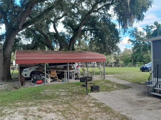 a view of a house with a yard porch and sitting area