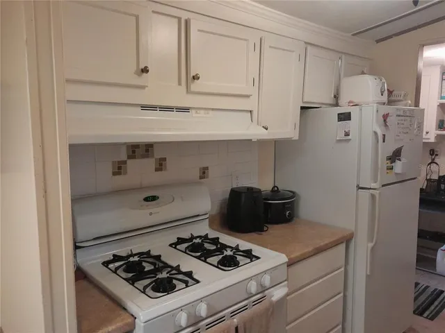a kitchen with stainless steel appliances granite countertop a refrigerator stove and sink