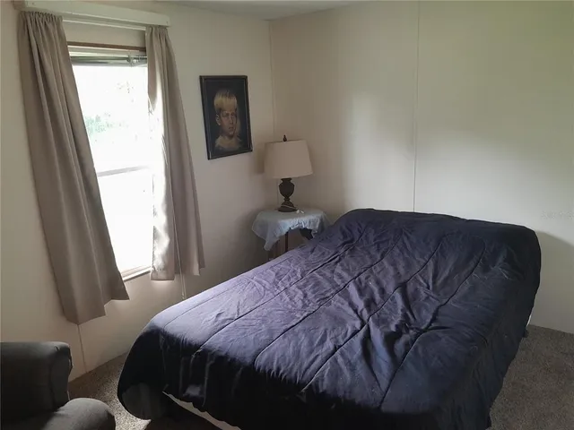a bedroom with a bed and furniture