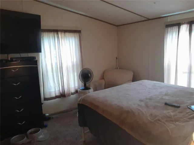 a bedroom with a bed and lamp