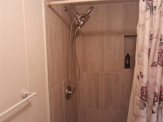 a bathroom with a shower curtain and a window