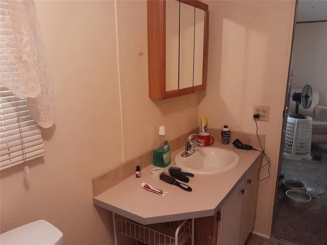a bathroom with a toilet a sink and shower