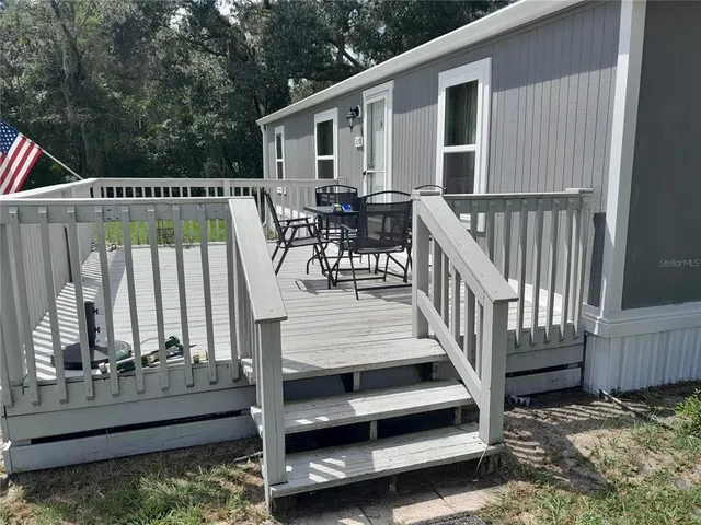 a view of balcony with wooden floor and outdoor seating