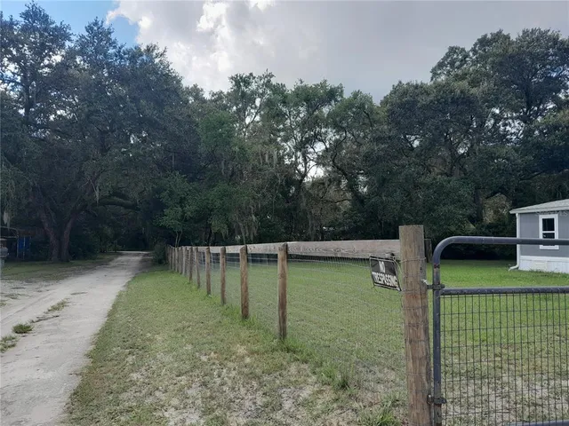 a view of a chairs and fire pit in the backyard