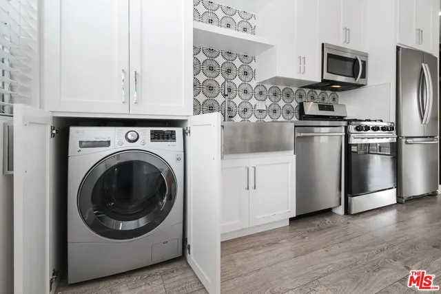 a kitchen with stainless steel appliances granite countertop a refrigerator and a stove top oven