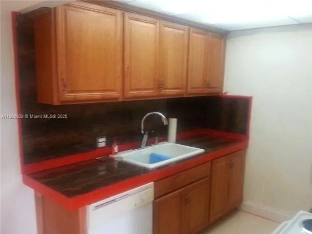a kitchen with a sink and cabinets