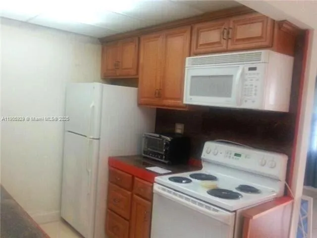 a kitchen with a stove and a cabinet