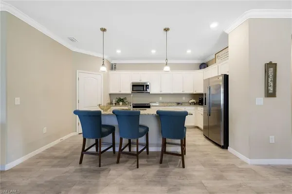 a large kitchen with a table and chairs