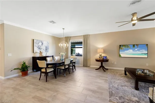 a living room with furniture a dining table and a window
