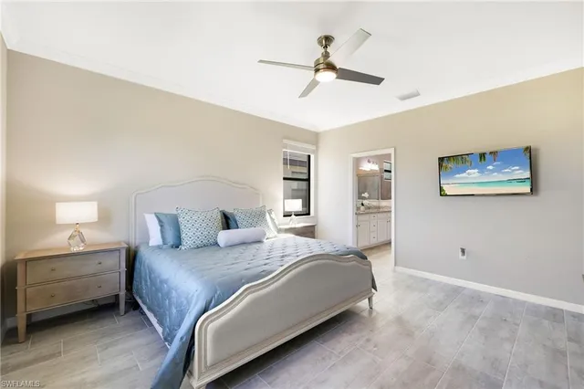 a bedroom with a large bed and a ceiling fan