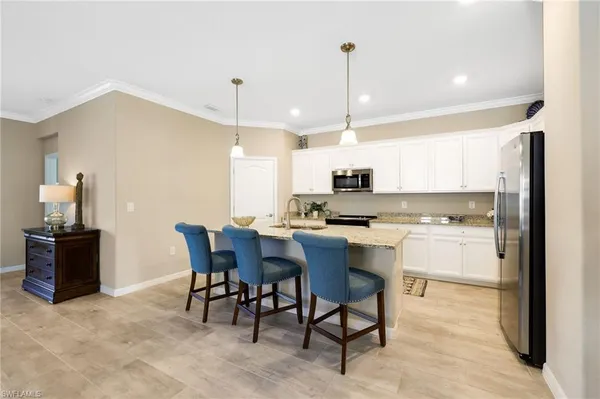 a kitchen with a sink cabinets and window