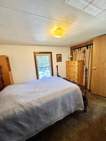 a bed sitting in a bedroom next to a window