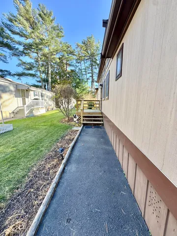 a view of a pathway of a house with a yard