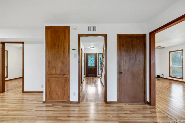 a view of a hallway with wooden floor and closet