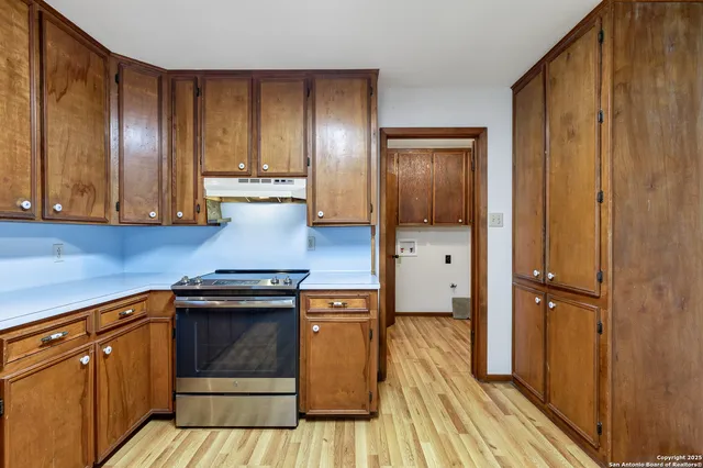 a kitchen with a sink stove and cabinets