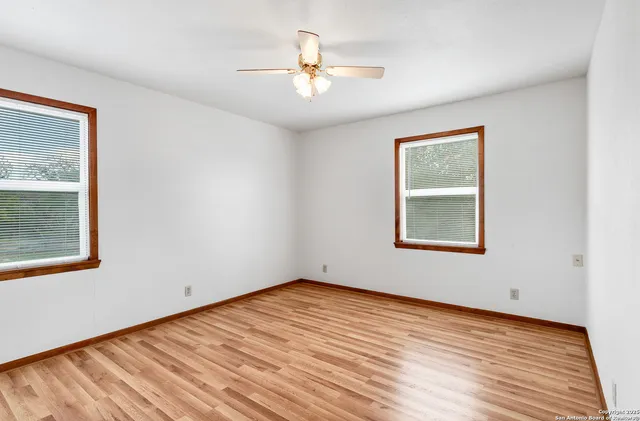 a view of a room with wooden floor and a window