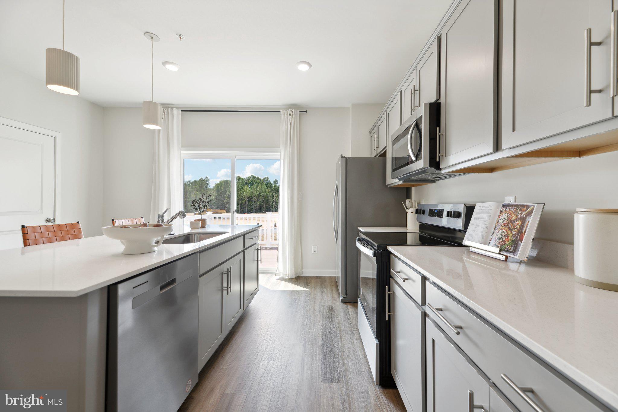 466 Still Feather Avenue La Plata, MD 20646 - Photo 25 of 89 a kitchen with a sink stove and cabinets
