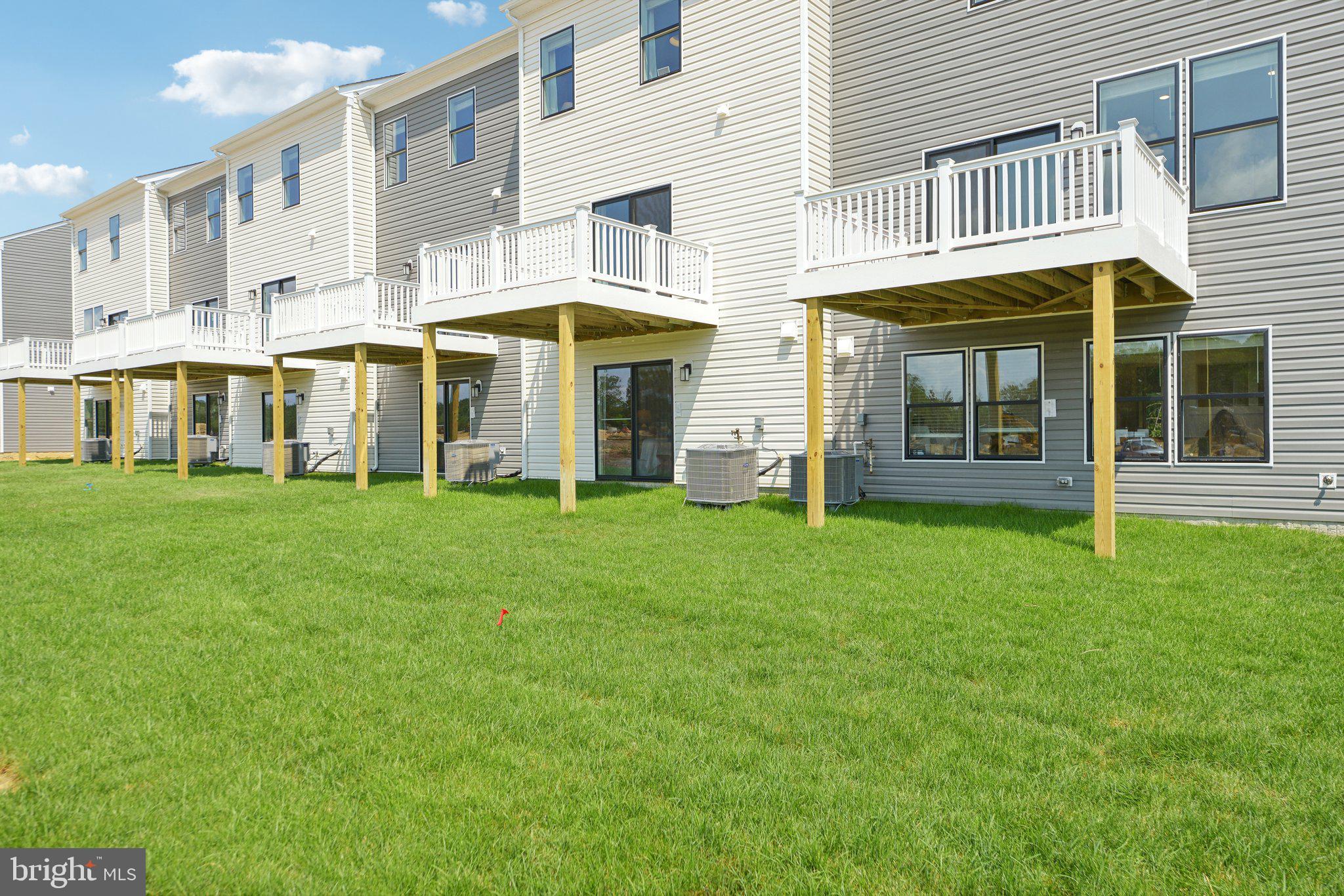466 Still Feather Avenue La Plata, MD 20646 - Photo 52 of 89 a front view of a residential apartment building with a yard